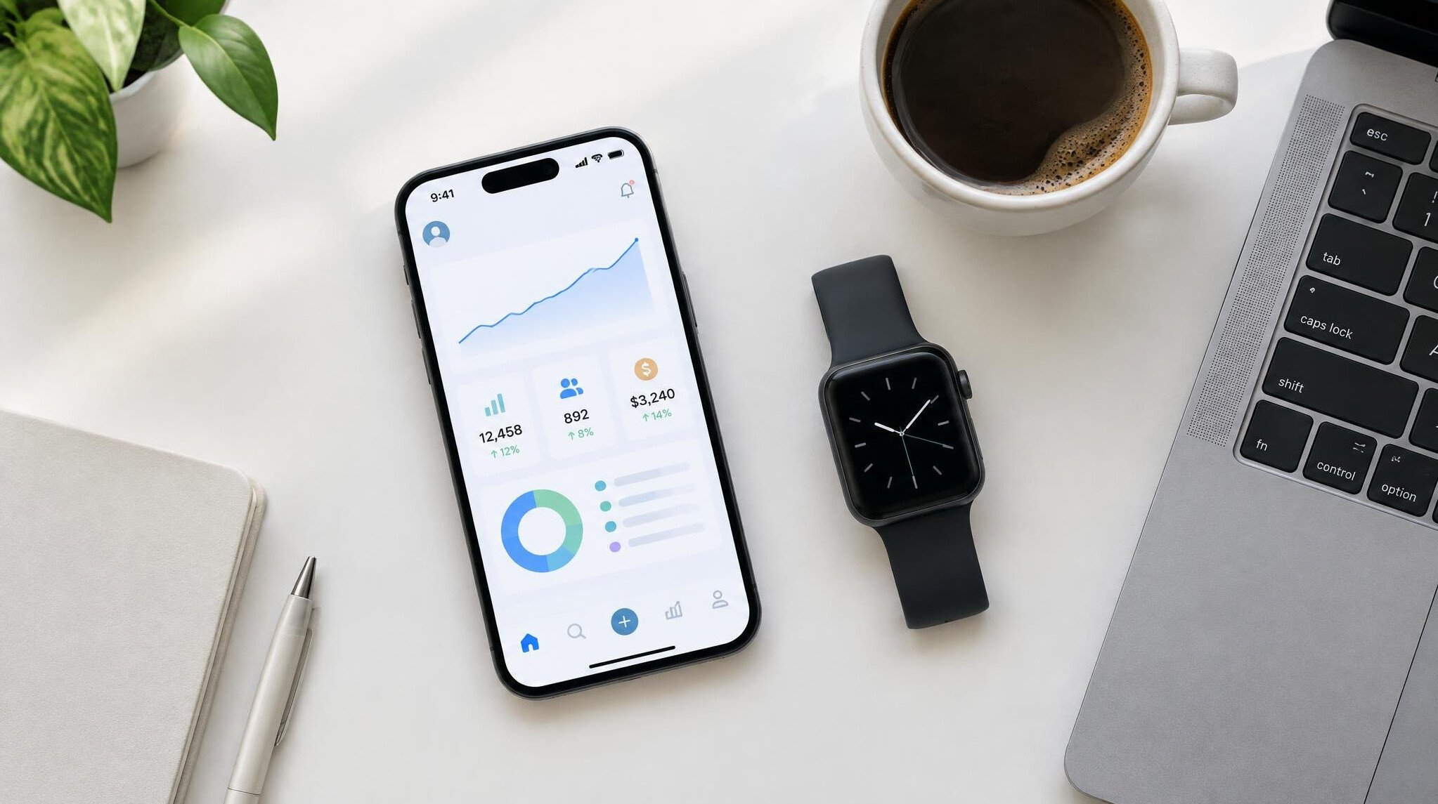 Desk with smartphone, smartwatch and coffee cup near a laptop
