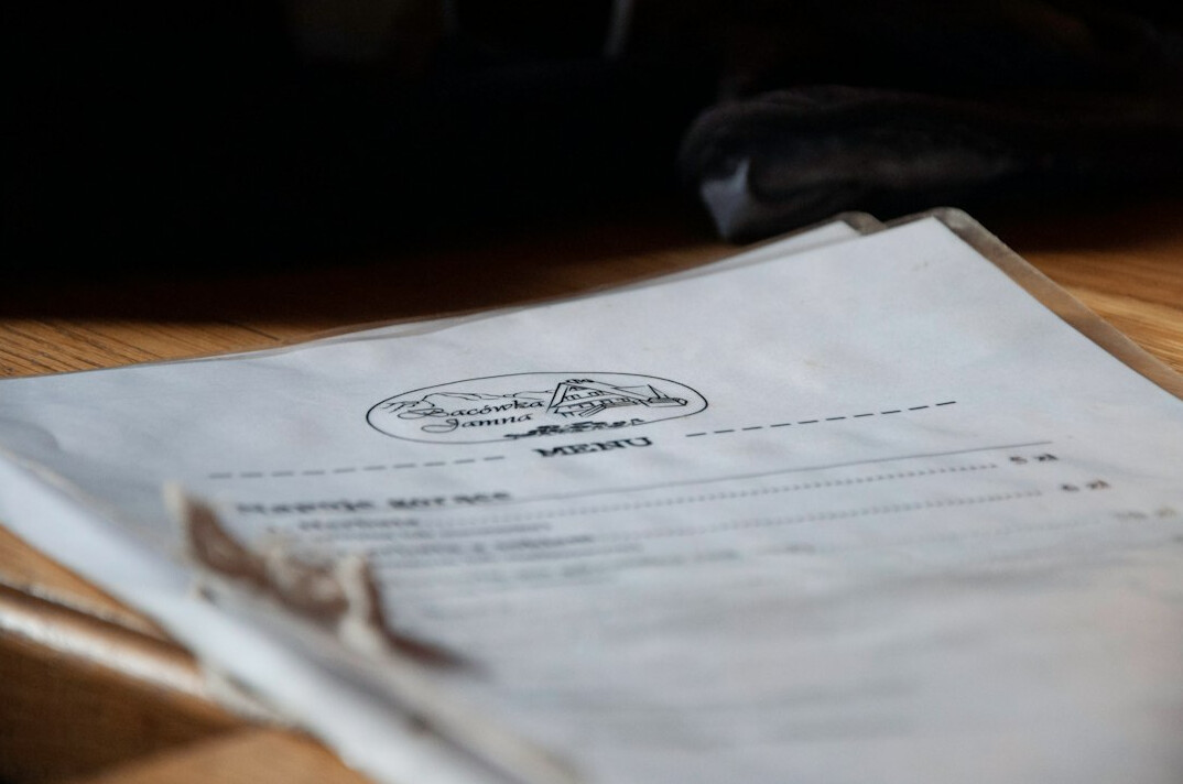 Hands reviewing printed documents and charts on a desk